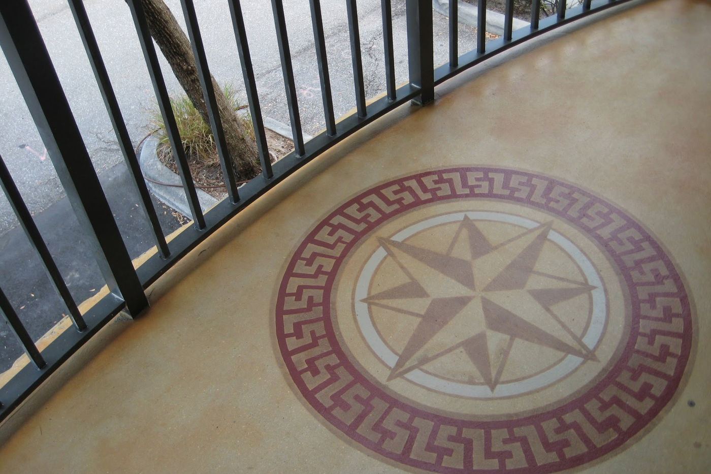 a coated outdoor surface with a compass medallion