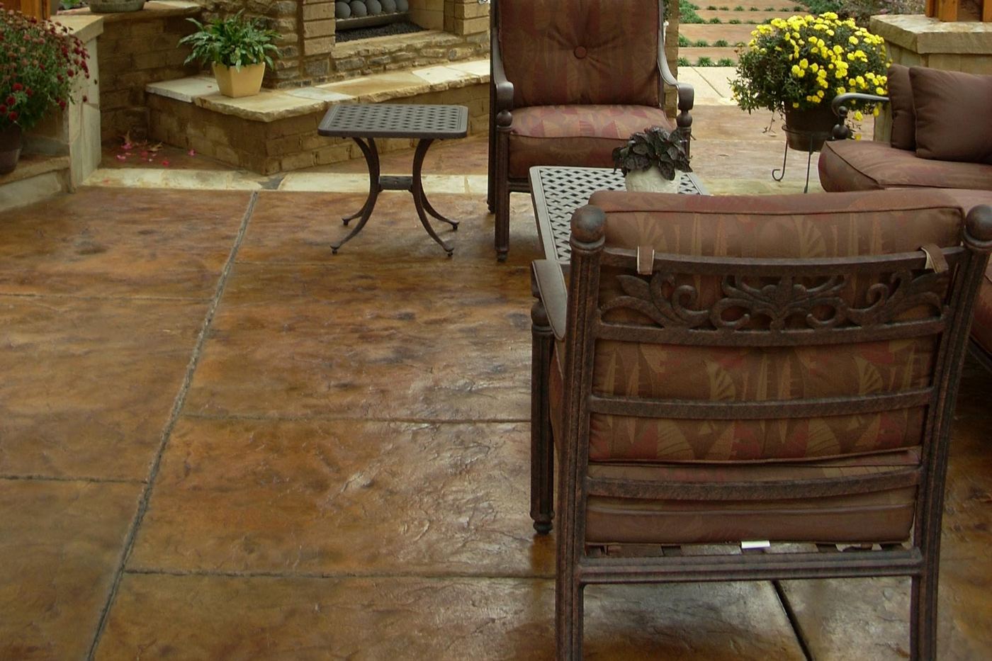 a stone-look patio finish with outdoor furniture