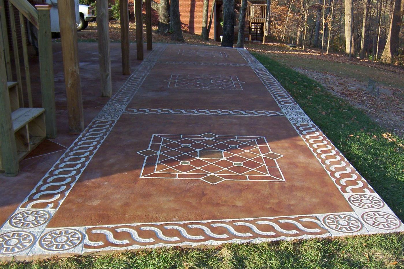 a long garden walkway with a patterned border