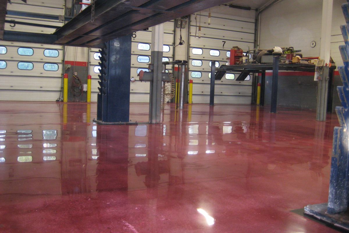 a high-gloss red floor in a working shop bay